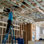 Construction crew working on ceiling systems inside a luxury residential renovation in Miromar Lakes, Florida