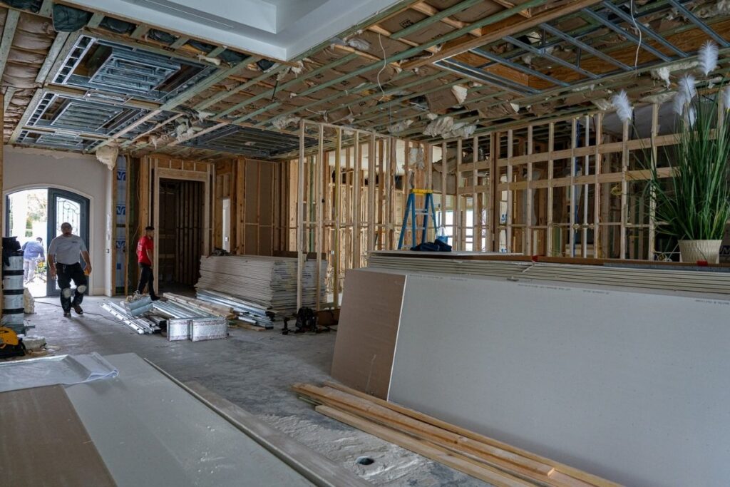 Wide view of open framing and exposed ceiling structure inside a luxury home renovation in Miromar Lakes, Florida