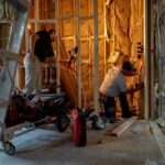 Crew working inside a framed room during a luxury residential renovation in Miromar Lakes, Florida