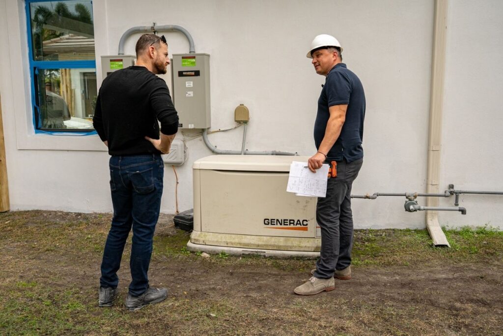 Project team reviewing an existing Generac standby generator at a luxury home renovation in Miromar Lakes, Florida