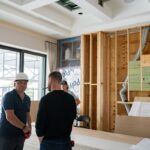 Project team discussing interior framing and renovation details inside a Miromar Lakes luxury home