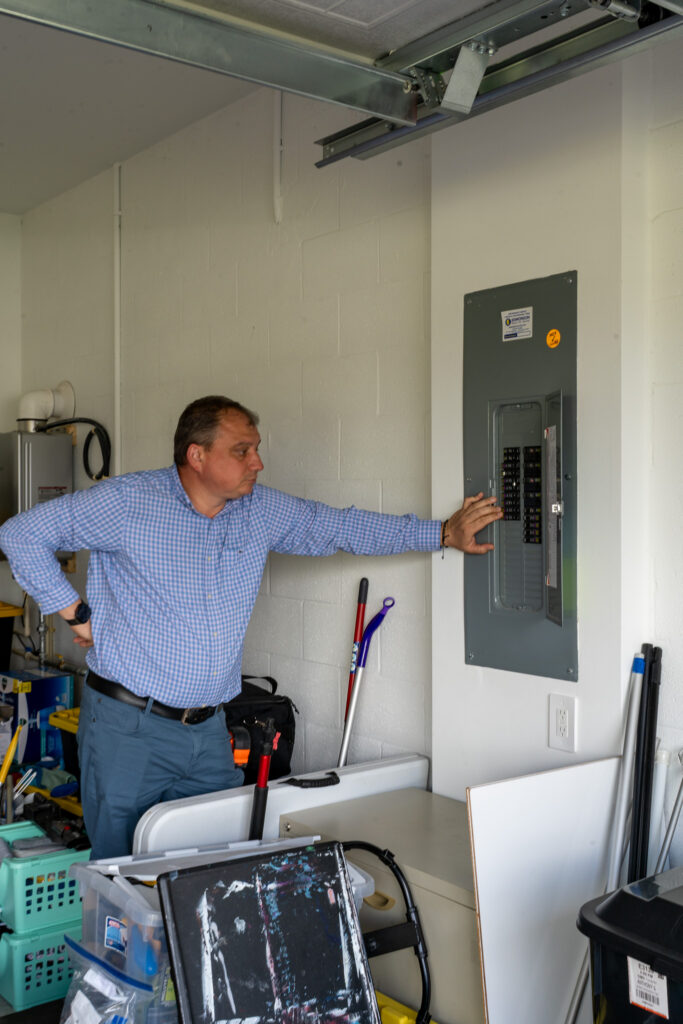 Residential electrical panel inspection showing where surge protection helps defend against lightning, outages, and voltage spikes.